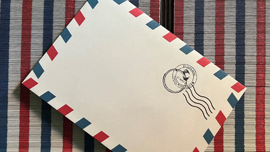 Our custom-designed airmail envelopes with the classic red and blue borders. Complemented with the rubber stamp printed in the top right corner of the airmail envelope. Accompaniment for our Vintage Travel Postcards.